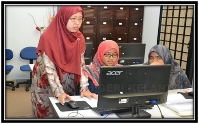 Peserta sedang mengemaskini maklumat sekolah sambil dibantu oleh Ustazah Siti Fatimah binti Mohd Bohari (Penolong Pengarah Bahagian Kemajuan Islam, JAKIM)